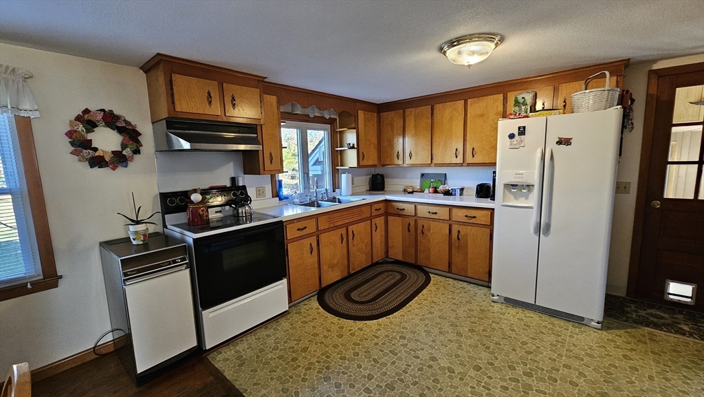 13 Capt Lathrop Drive Deerfield, MA 01373 - Photo 11 of 34 a kitchen with stainless steel appliances granite countertop a refrigerator stove and sink