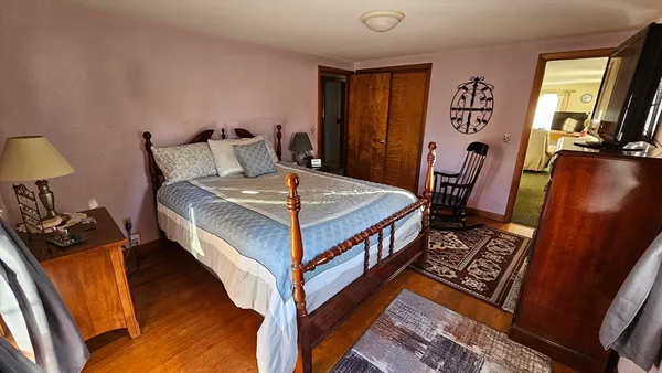 a bedroom with bed and a dresser