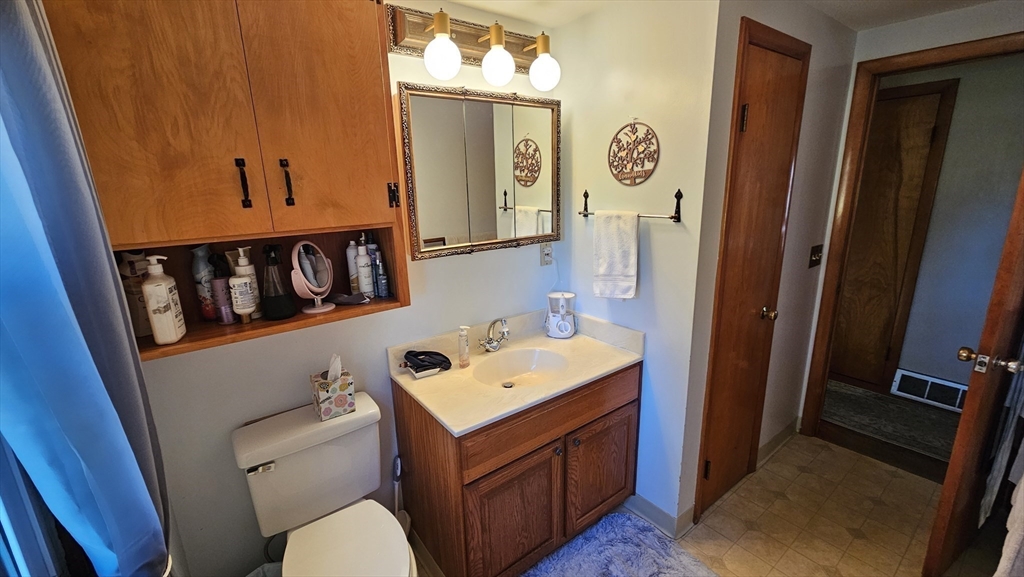 13 Capt Lathrop Drive Deerfield, MA 01373 - Photo 22 of 34 a bathroom with a sink a mirror and a toilet