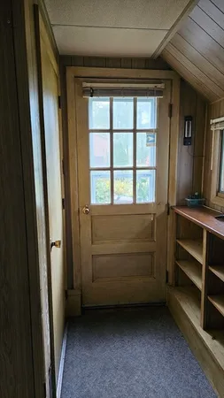 a view of an empty room and a window