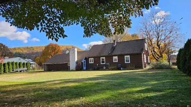 a view of house with a big yard