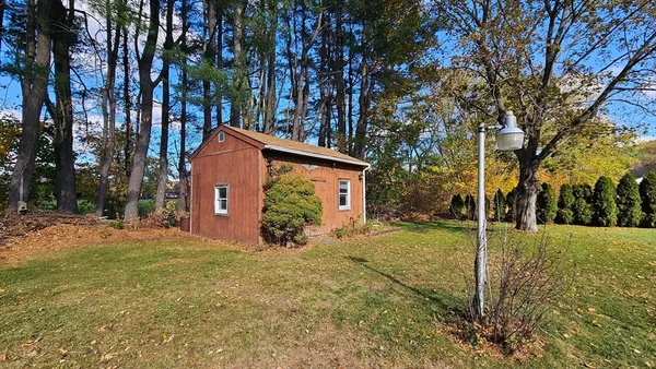 a view of a house with a yard covered in snow