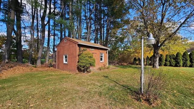 a view of a house with a yard covered in snow