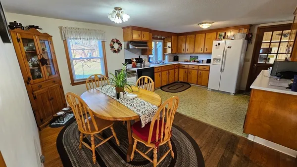 a view of a dining room with furniture and a window