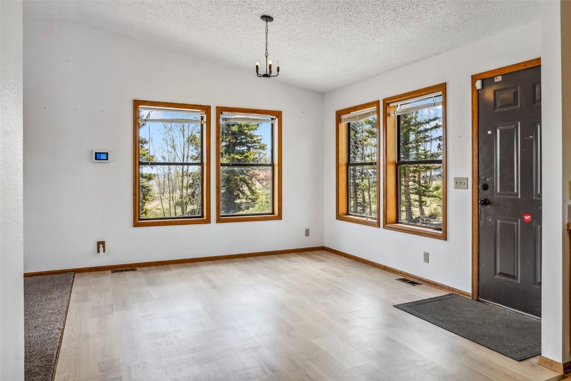 681 Sheep Ridge Road Fairplay, CO 80440 - Photo 10 of 43 a view of an empty room with a window and wooden floor