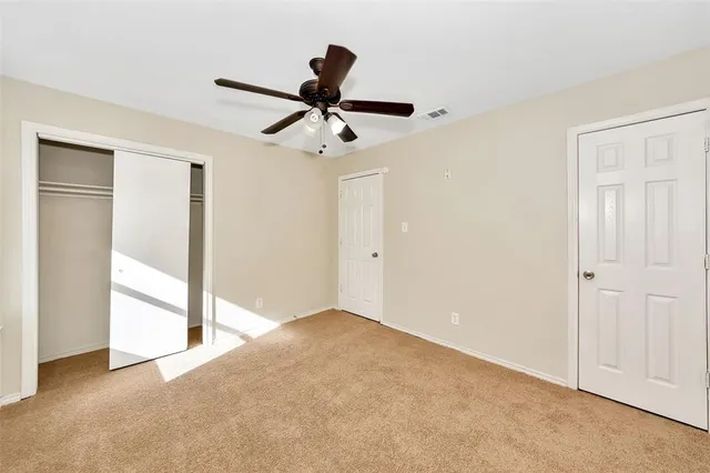 a view of empty room with ceiling fan