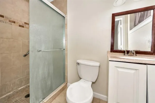 a bathroom with a toilet sink and shower