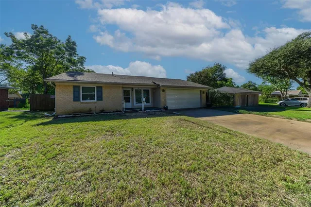 a view of house with outdoor space and garden