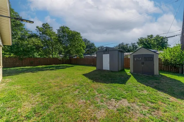 a view of house with a yard