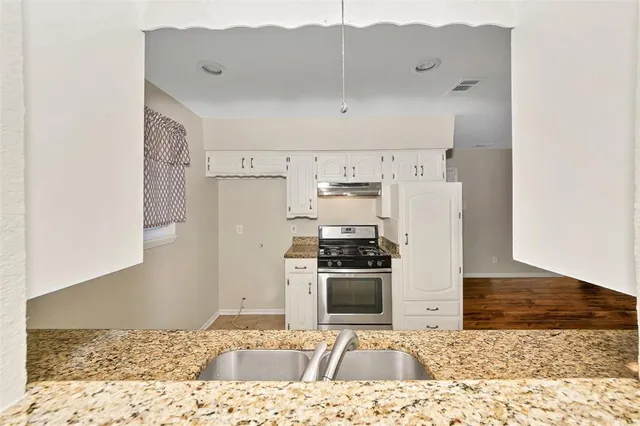 a kitchen with stainless steel appliances kitchen island granite countertop a refrigerator sink and stove