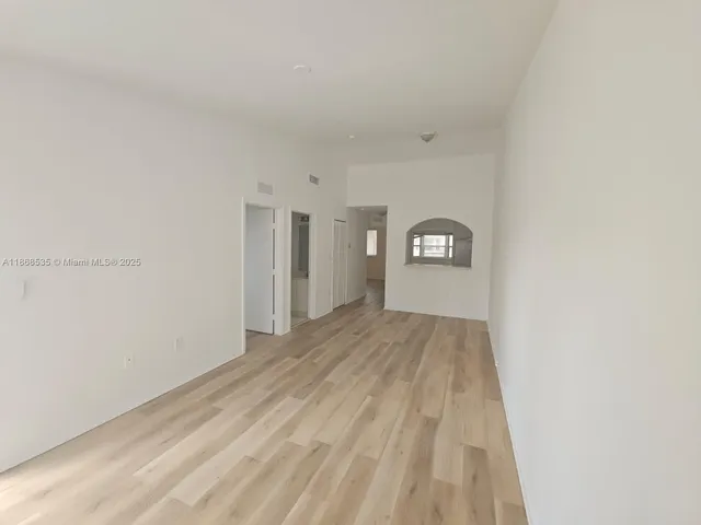 a view of a big room with closet and window