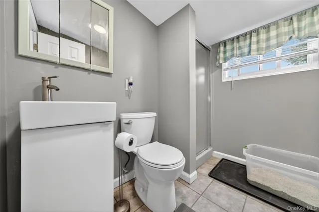 a white toilet sitting next to a bathroom sink