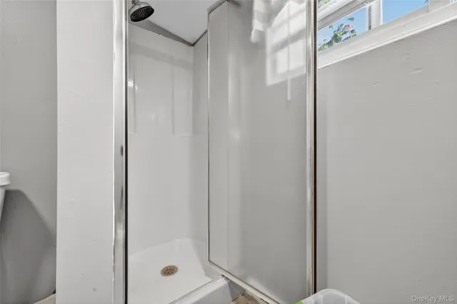 a bathroom with a glass shower door