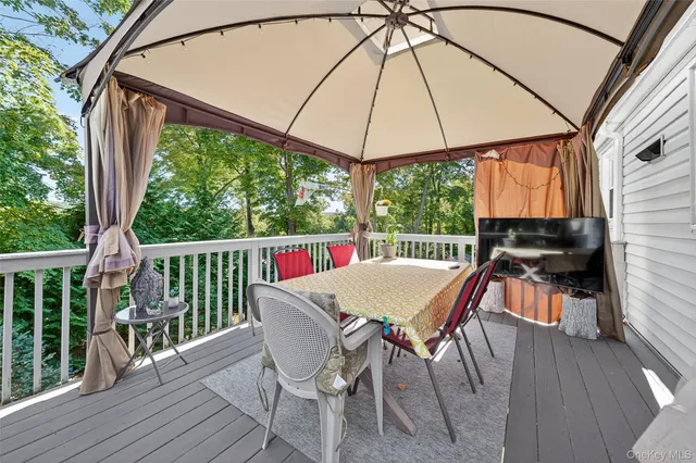 a outdoor view with a sitting space and large trees