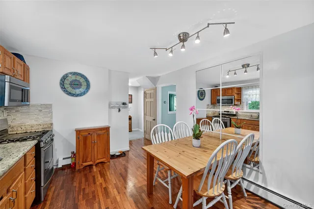 a dining room with furniture and wooden floor