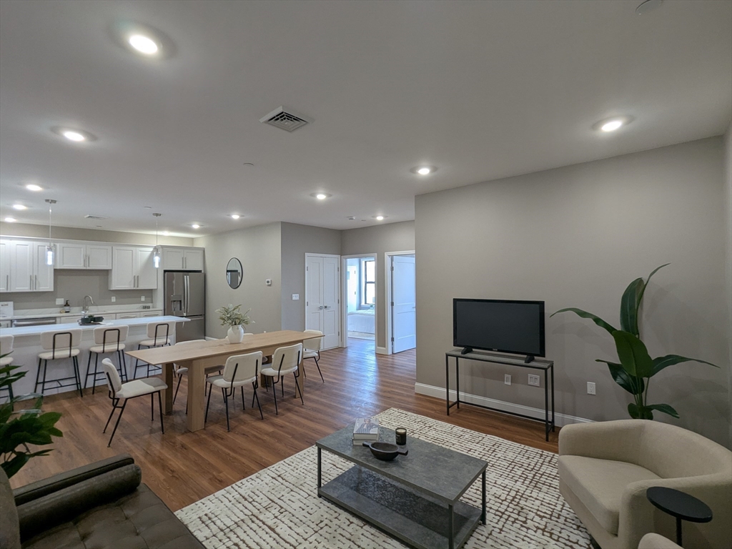 a living room with lots of furniture and a wooden floor