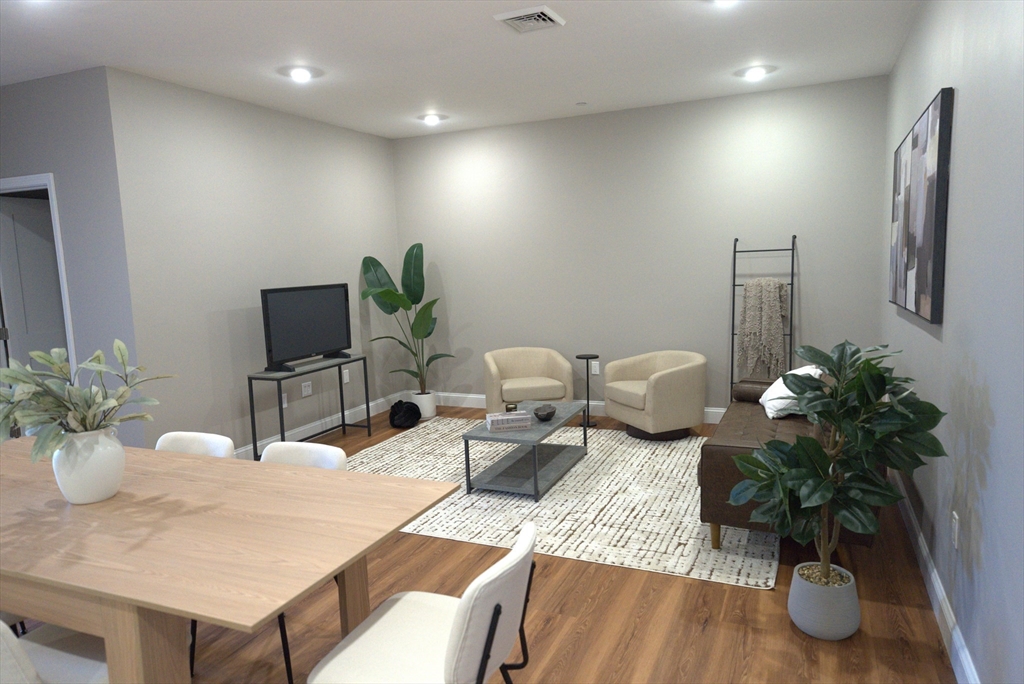 13 Nahant Street, Unit 4B Lynn, MA 01902 - Photo 11 of 28 a living room with furniture potted plant and a lamp