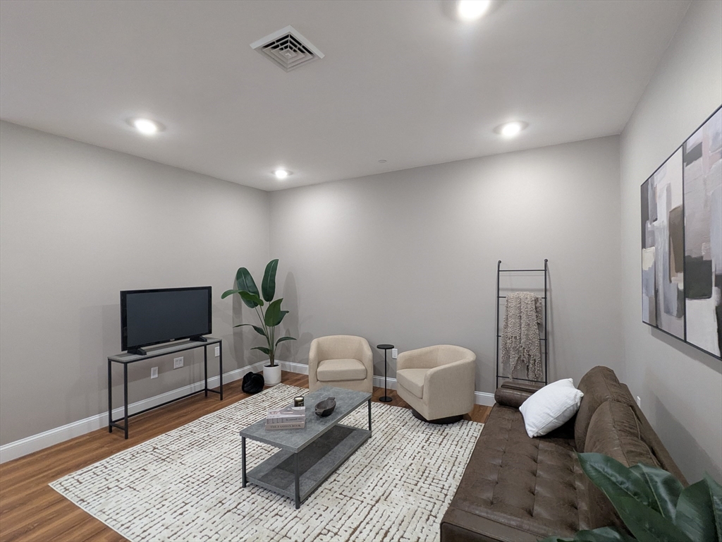 13 Nahant Street, Unit 4B Lynn, MA 01902 - Photo 13 of 28 a living room with furniture and a flat screen tv