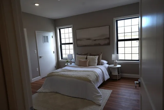 a bedroom with a bed and a window