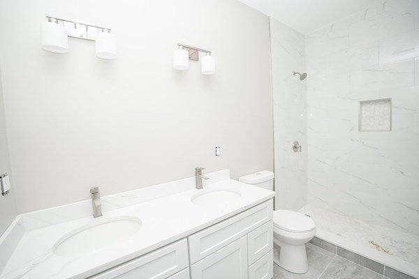 13 Nahant Street, Unit 4B Lynn, MA 01902 - Photo 20 of 28 a bathroom with a sink a toilet and shower