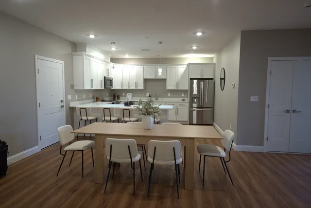 a dining room with kitchen island a table and chairs