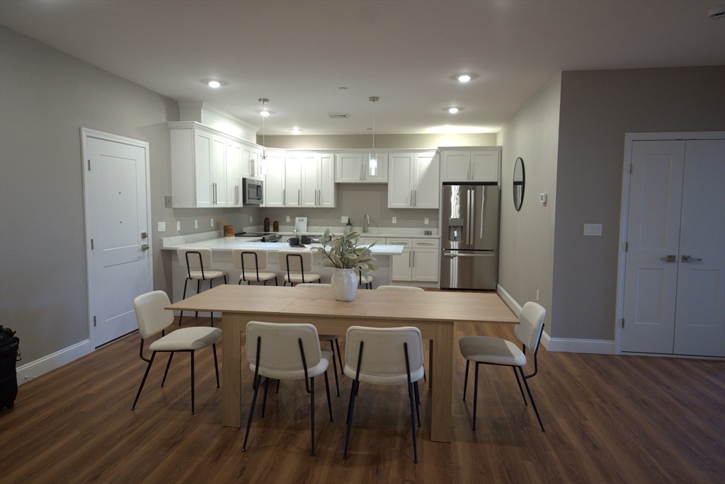 13 Nahant Street, Unit 4B Lynn, MA 01902 - Photo 6 of 28 a dining room with kitchen island a table and chairs
