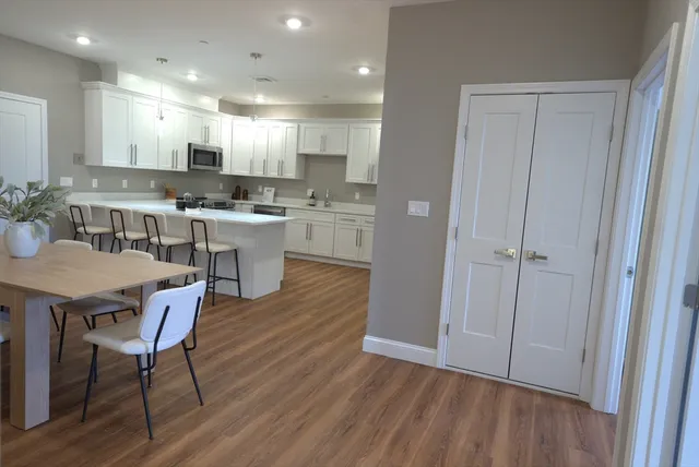 a kitchen with a table and chairs in it