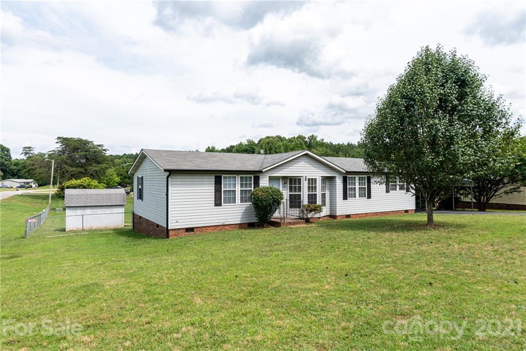 3034 St James Church Road Denver, NC 28037 - Photo 2 of 23 a front view of a house with a garden and trees