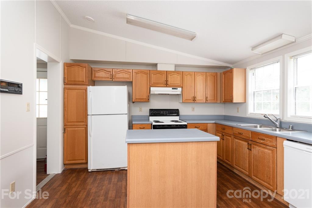 3034 St James Church Road Denver, NC 28037 - Photo 11 of 23 a kitchen with a refrigerator a sink and wooden floor