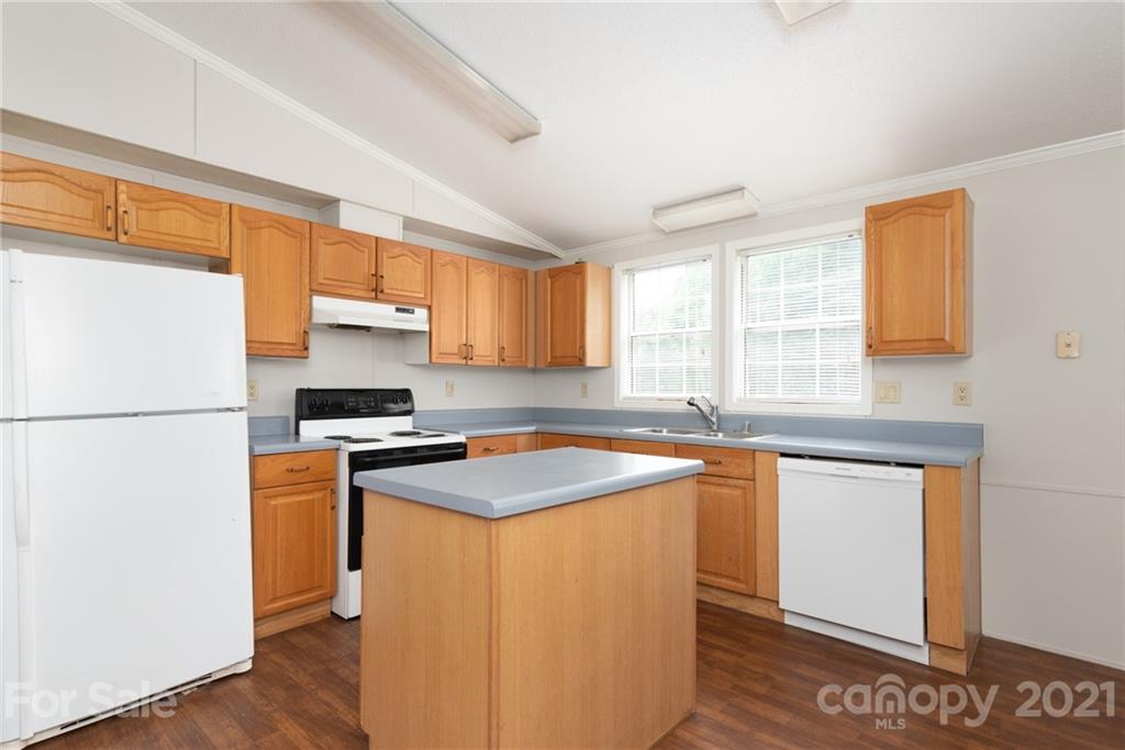 3034 St James Church Road Denver, NC 28037 - Photo 12 of 23 a kitchen with stainless steel appliances a refrigerator sink and wooden cabinets