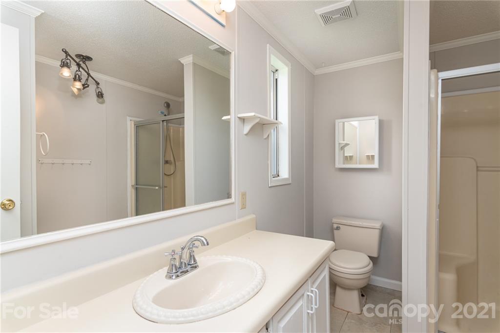 3034 St James Church Road Denver, NC 28037 - Photo 14 of 23 a bathroom with a sink toilet and shower