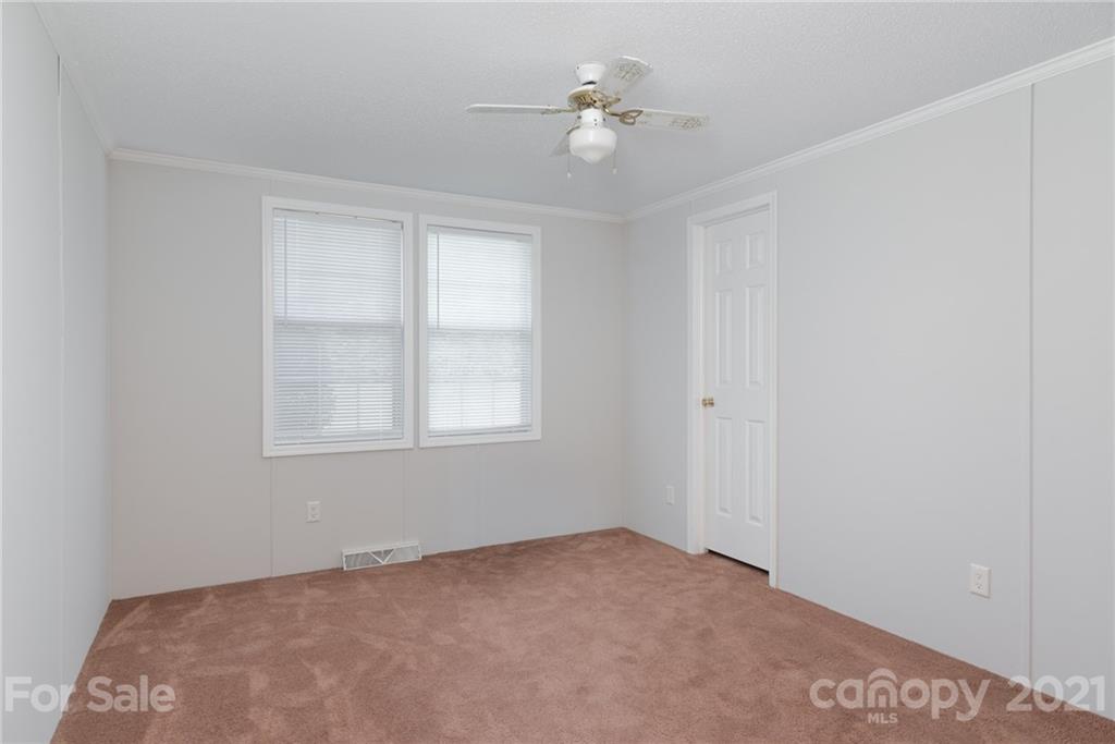 3034 St James Church Road Denver, NC 28037 - Photo 18 of 23 an empty room with windows and ceiling fan