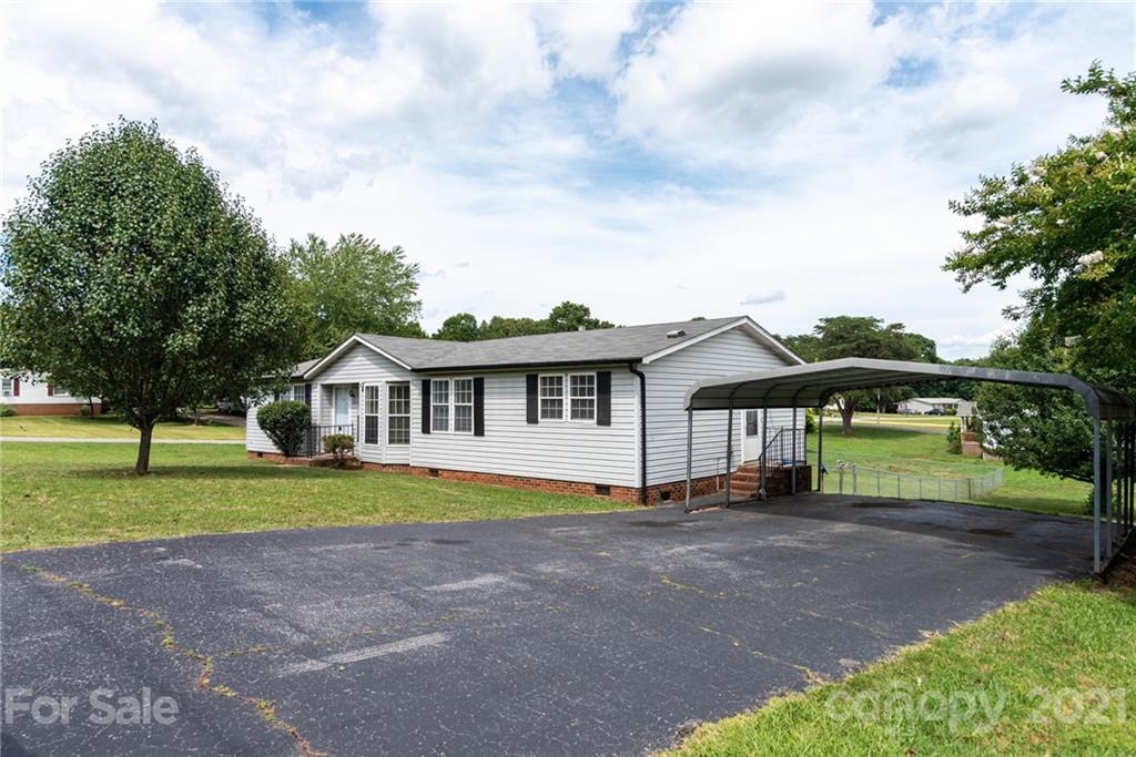 3034 St James Church Road Denver, NC 28037 - Photo 3 of 23 a front view of a house with a yard and garage