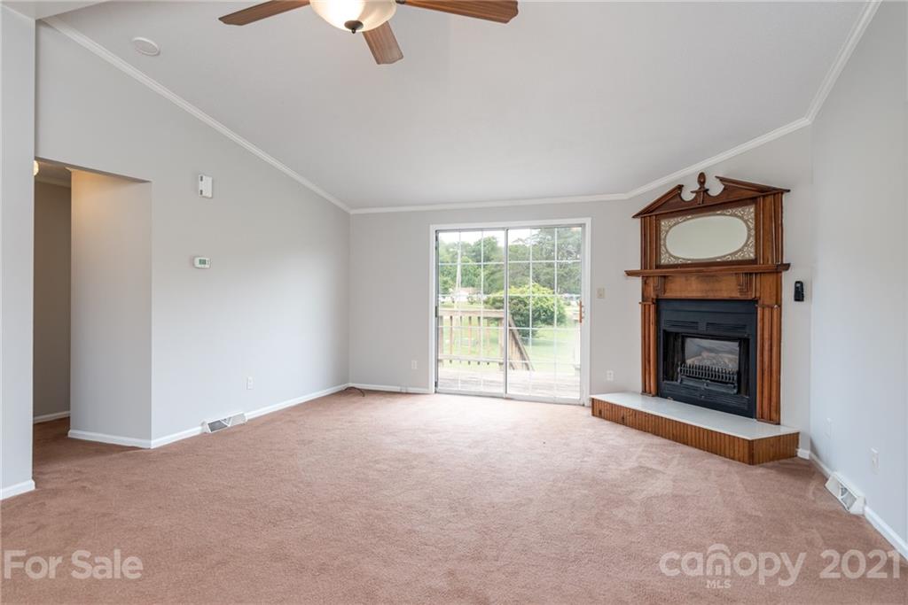 3034 St James Church Road Denver, NC 28037 - Photo 5 of 23 an empty room with fireplace and windows