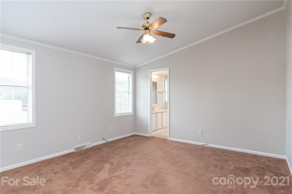 3034 St James Church Road Denver, NC 28037 - Photo 8 of 23 a view of a room with a ceiling fan and a window