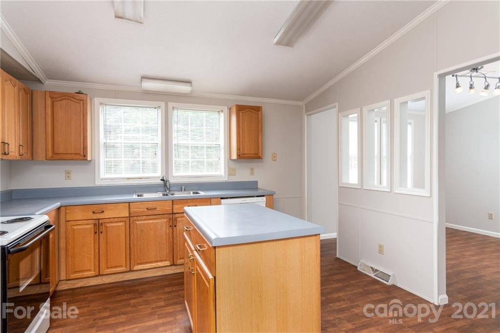 3034 St James Church Road Denver, NC 28037 - Photo 10 of 23 a kitchen with stainless steel appliances granite countertop a sink stove and cabinets