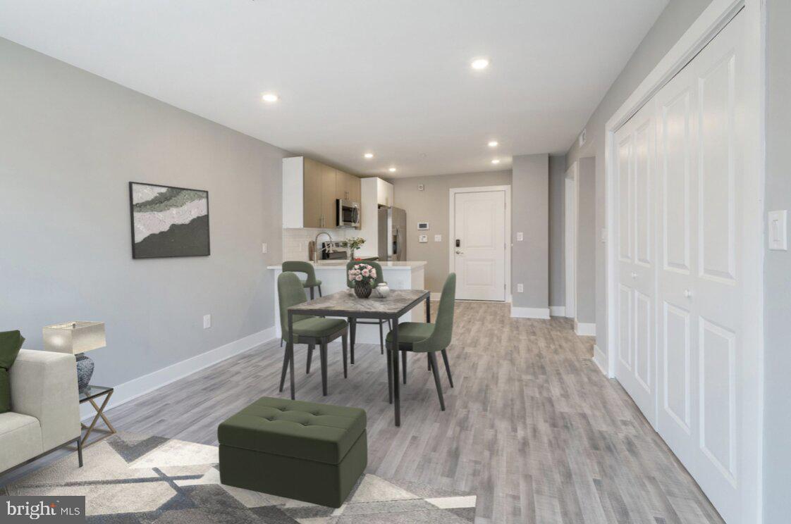 a view of a dining room with furniture and wooden floor