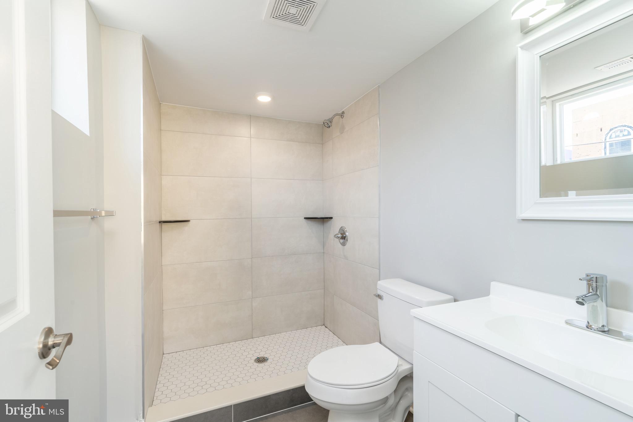 2500 North Mascher Street, Unit 9 Philadelphia, PA 19133 - Photo 14 of 17 a bathroom with a toilet a sink a shower and a mirror