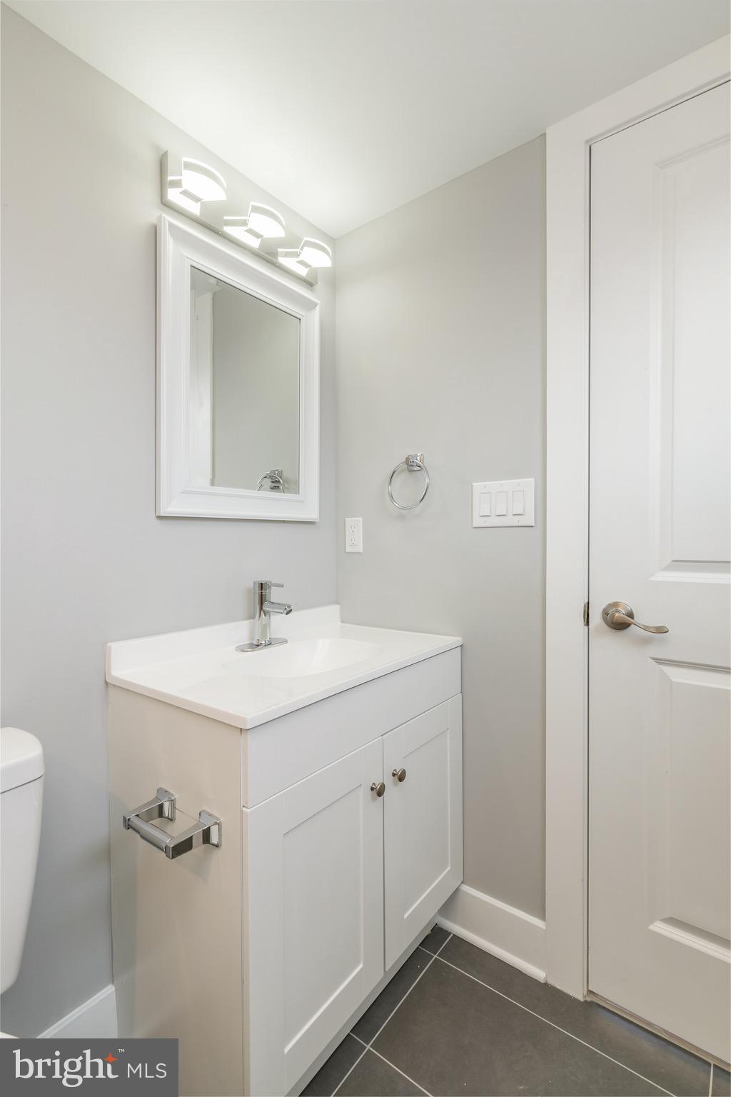 2500 North Mascher Street, Unit 9 Philadelphia, PA 19133 - Photo 16 of 17 a bathroom with a sink a toilet a mirror and shower