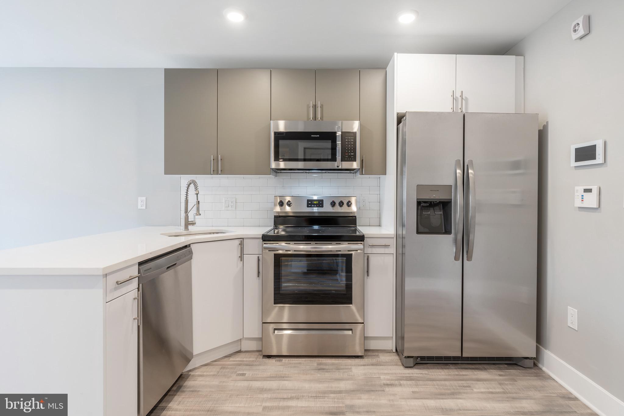 2500 North Mascher Street, Unit 9 Philadelphia, PA 19133 - Photo 3 of 17 a kitchen with a refrigerator stove and microwave