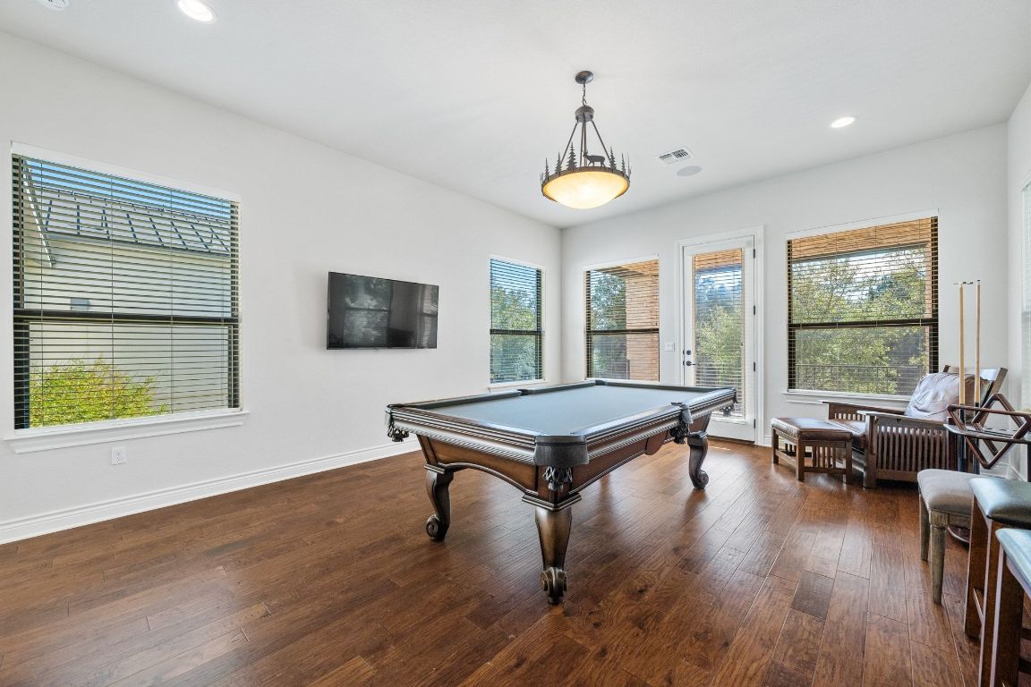 20607 Thurman Bend Road Spicewood, TX 78669 - Photo 18 of 40 Playroom with recessed lighting, dark wood-style flooring, billiards table, and healthy amount of natural light