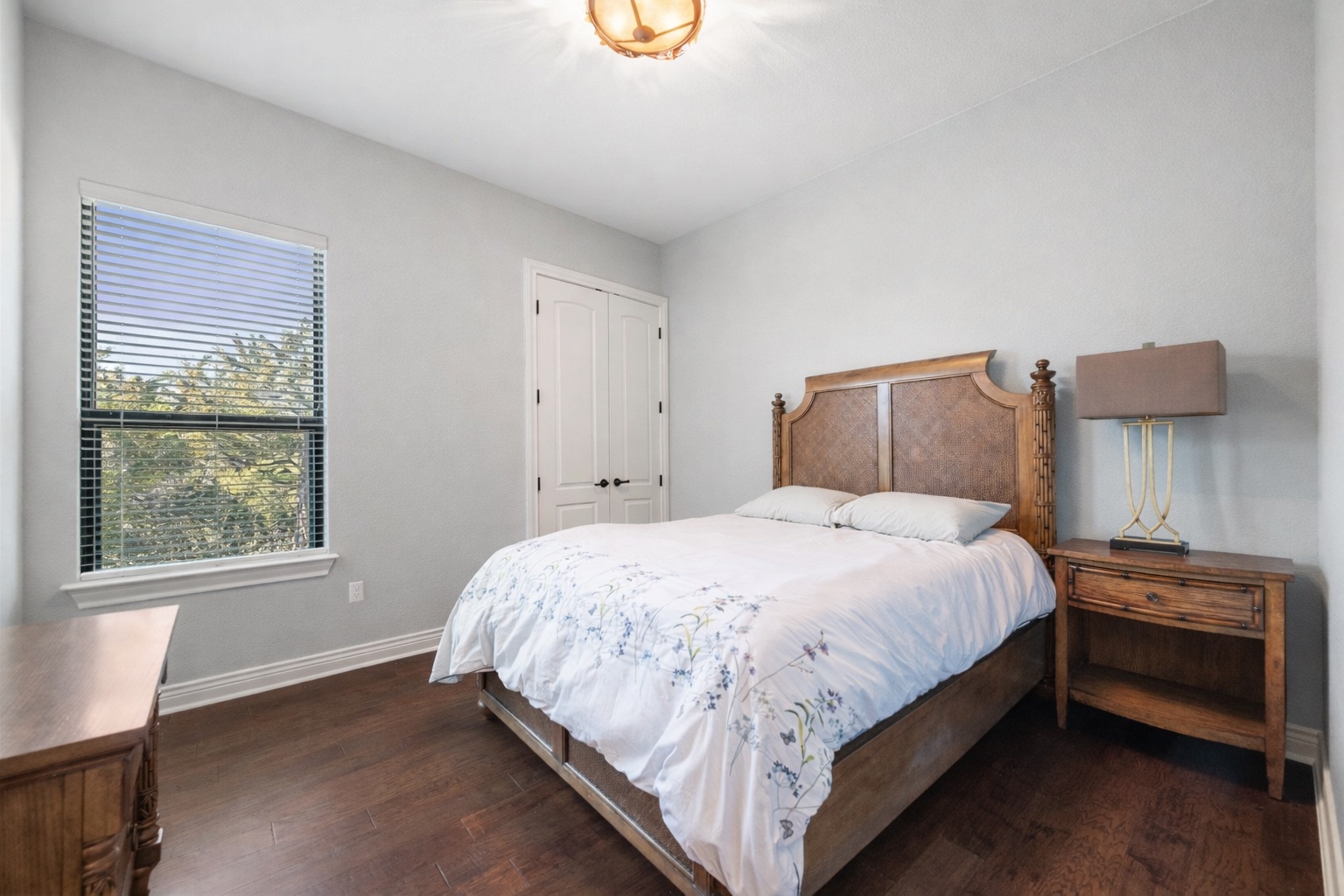 20607 Thurman Bend Road Spicewood, TX 78669 - Photo 20 of 39 a bedroom with a bed and a window