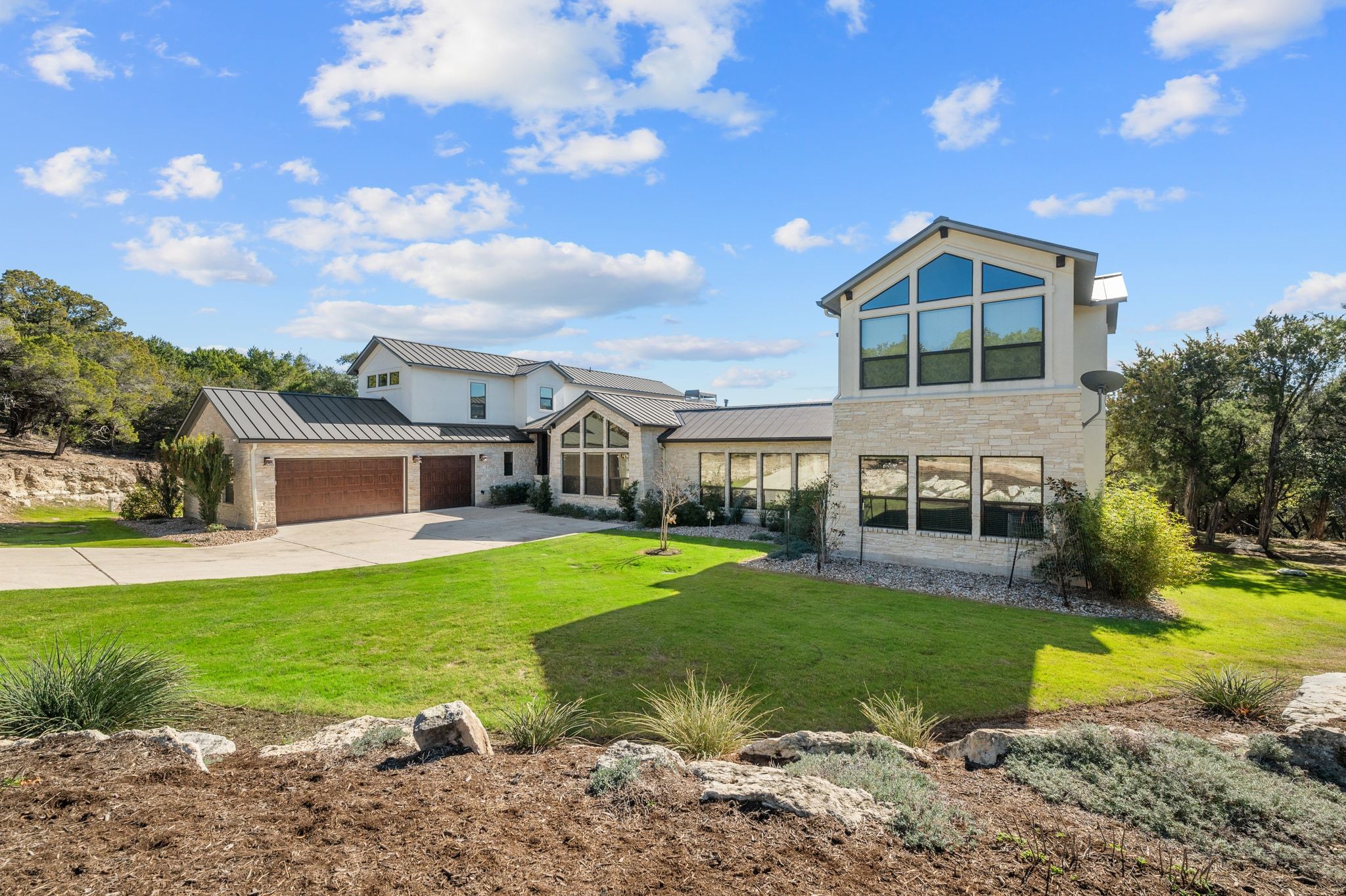 20607 Thurman Bend Road Spicewood, TX 78669 - Photo 2 of 39 a front view of house with yard and green space
