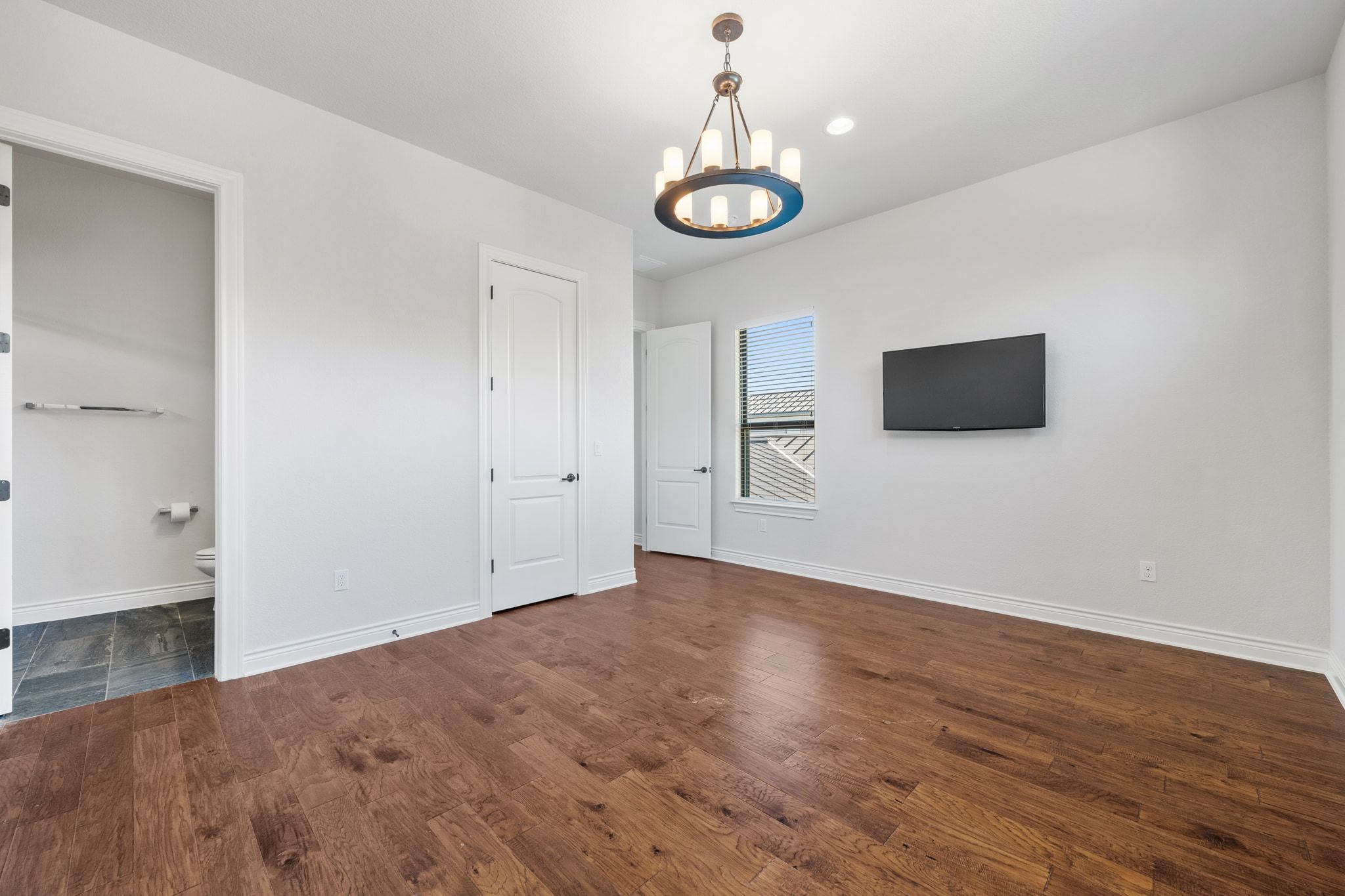 20607 Thurman Bend Road Spicewood, TX 78669 - Photo 23 of 39 a view of empty room with wooden floor