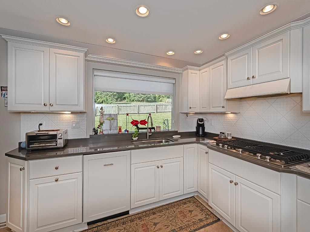 9745 Lindsay Road Pittsburgh, PA 15237 - Photo 13 of 36 a kitchen with granite countertop white cabinets and white appliances