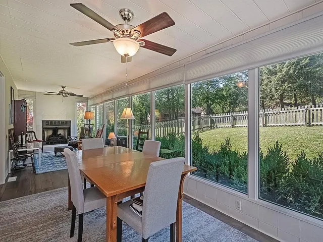 a view of a dining room with furniture large windows and wooden floor