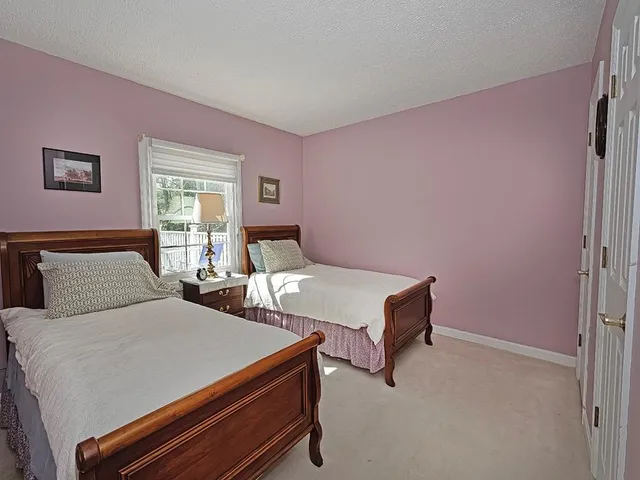 a bedroom with two beds and a window