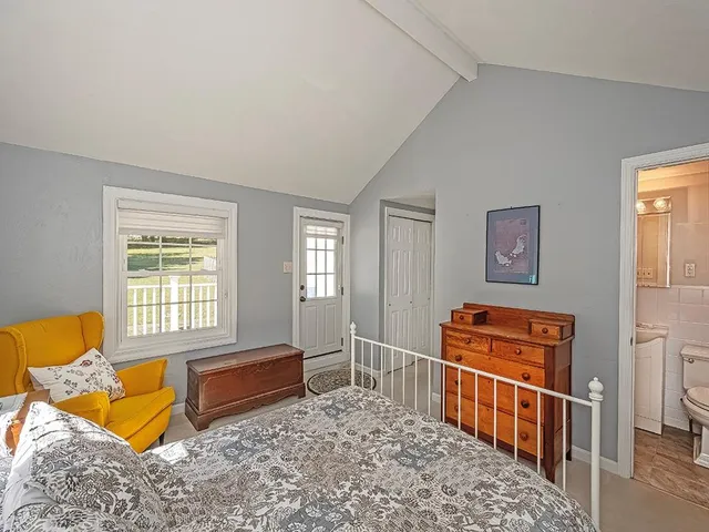 a bedroom with furniture and a window