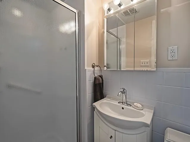 a bathroom with a sink a toilet and mirror