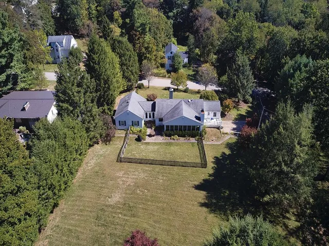 an aerial view of a house with yard swimming pool and outdoor seating
